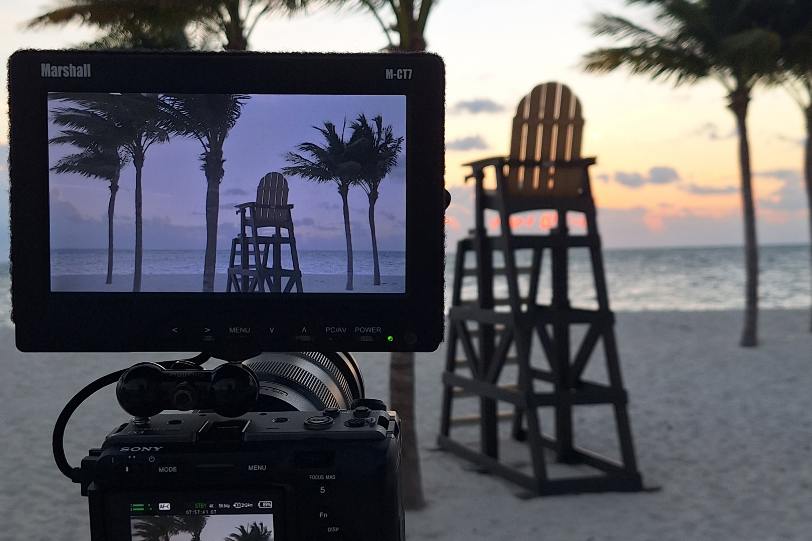 Camera monitor framing a lifeguard tower at sunrise on a South Florida beach